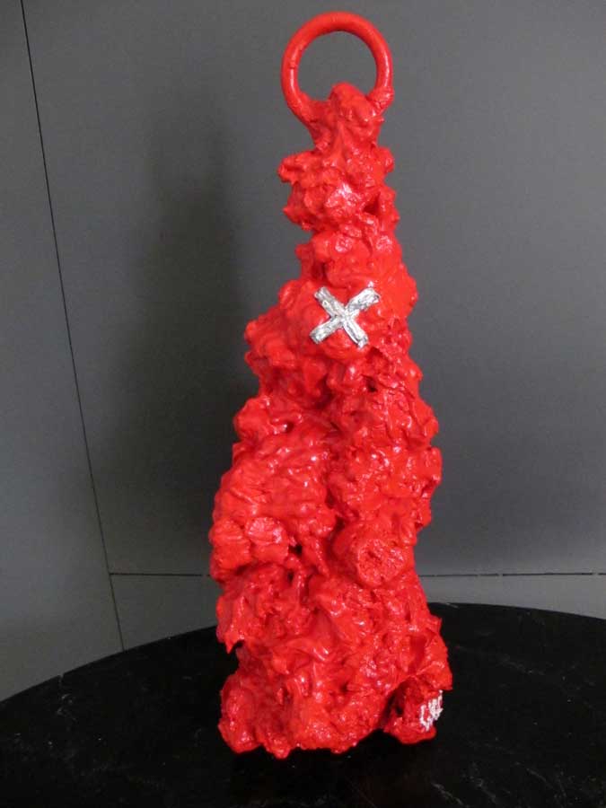 X on red, sculpture by Nicola Guerraz, mixed media on pumice, h 69 cm, 2013